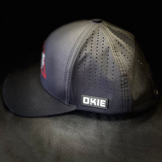 Side angle of the JRW x OKIE Black Magic golf hat showcasing the low-profile fit and breathable mesh panel, emphasizing the sleek, athletic silhouette.
